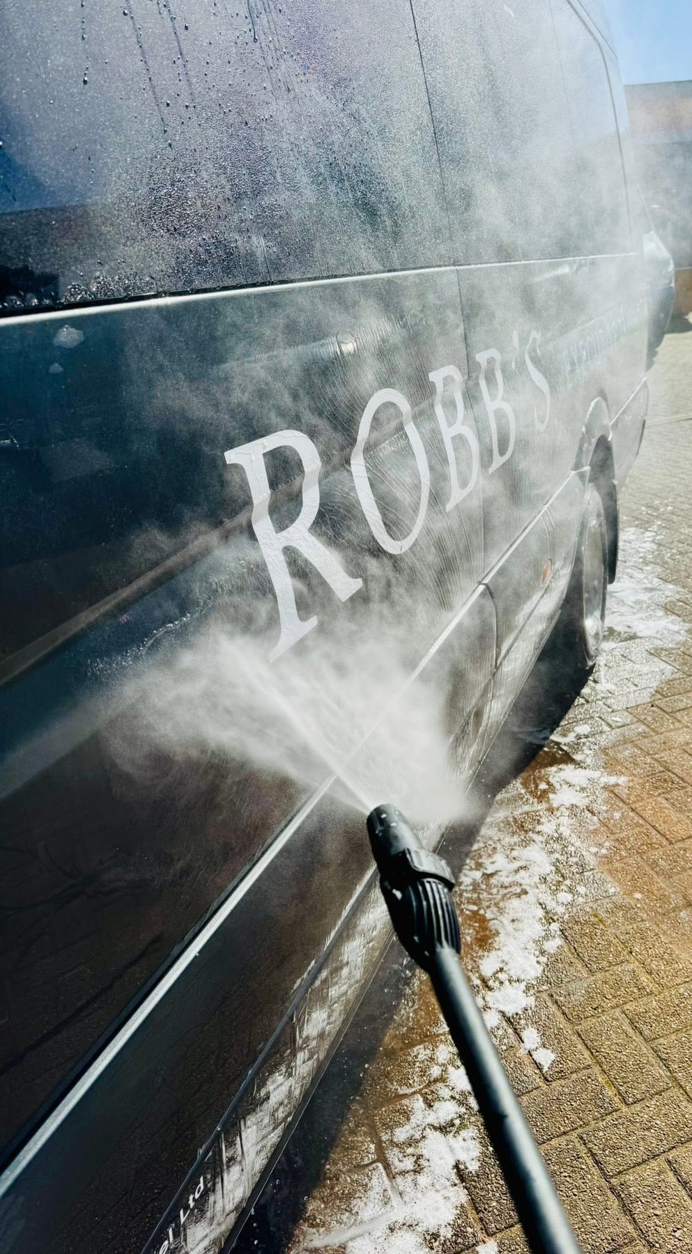 Robb's coach being pressure-washed