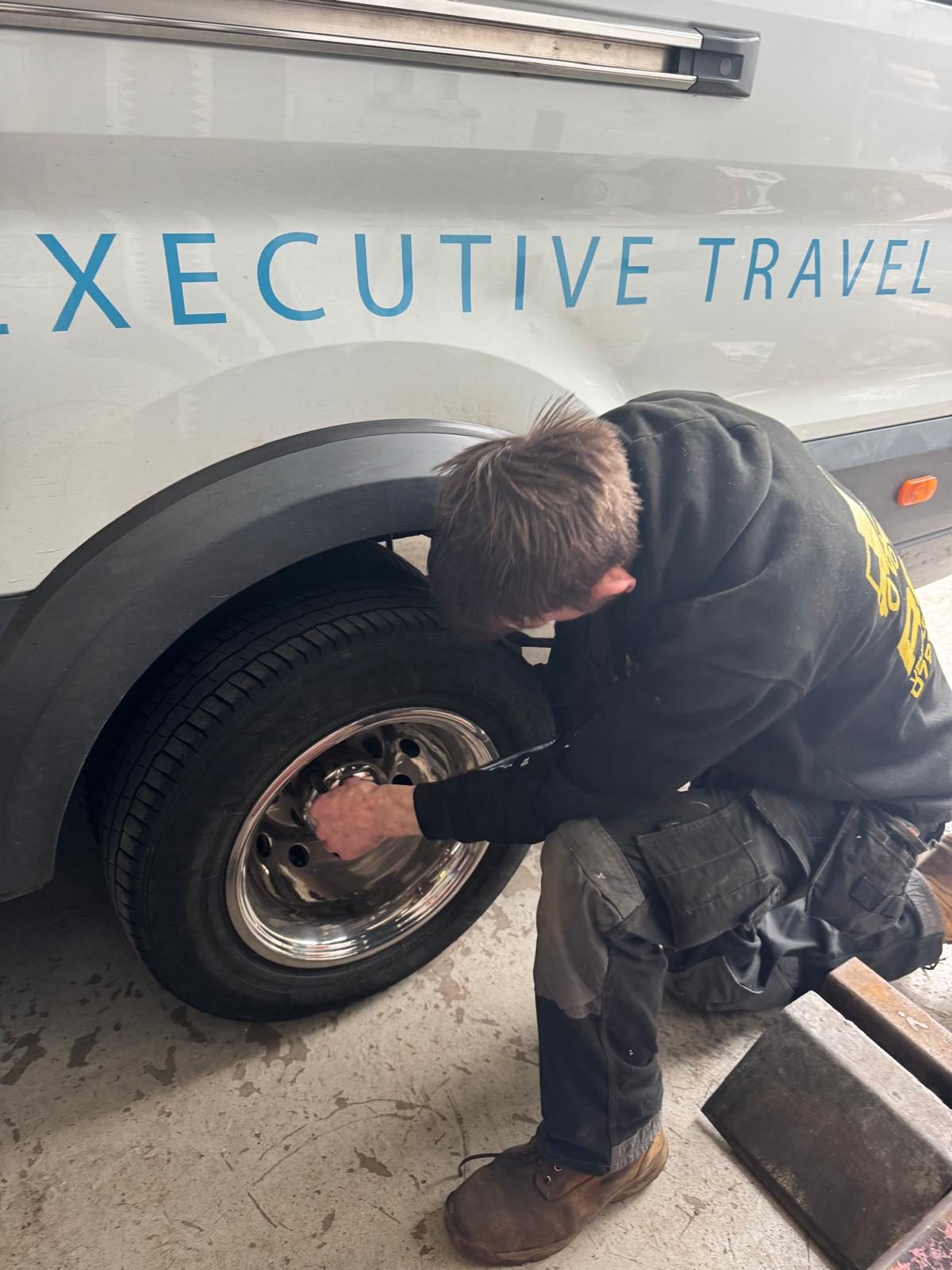 Robb's team member checking a wheel during a daily walk-round check
