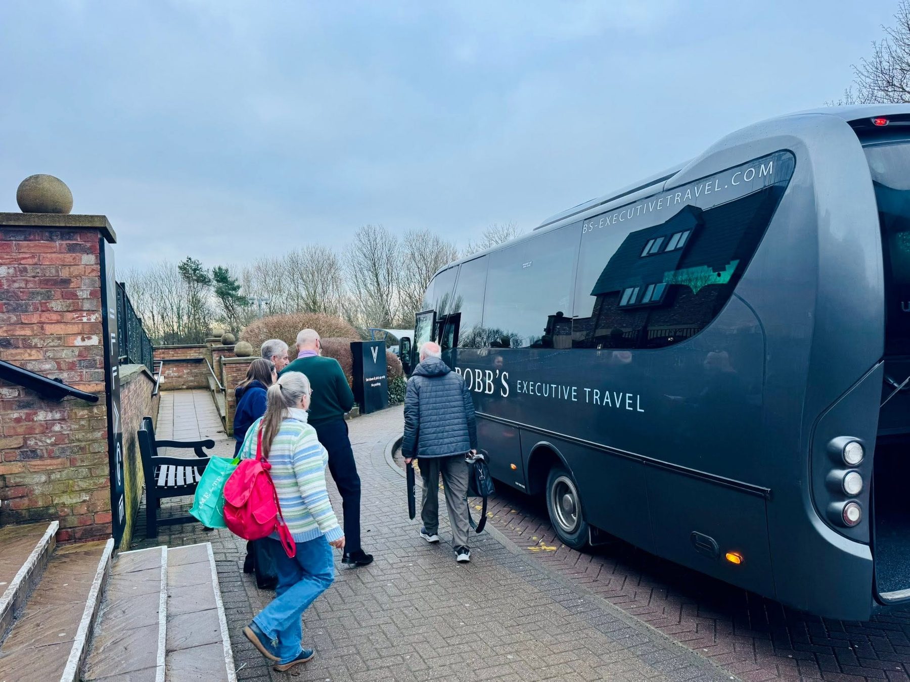 Passengers boarding a Robb's coach
