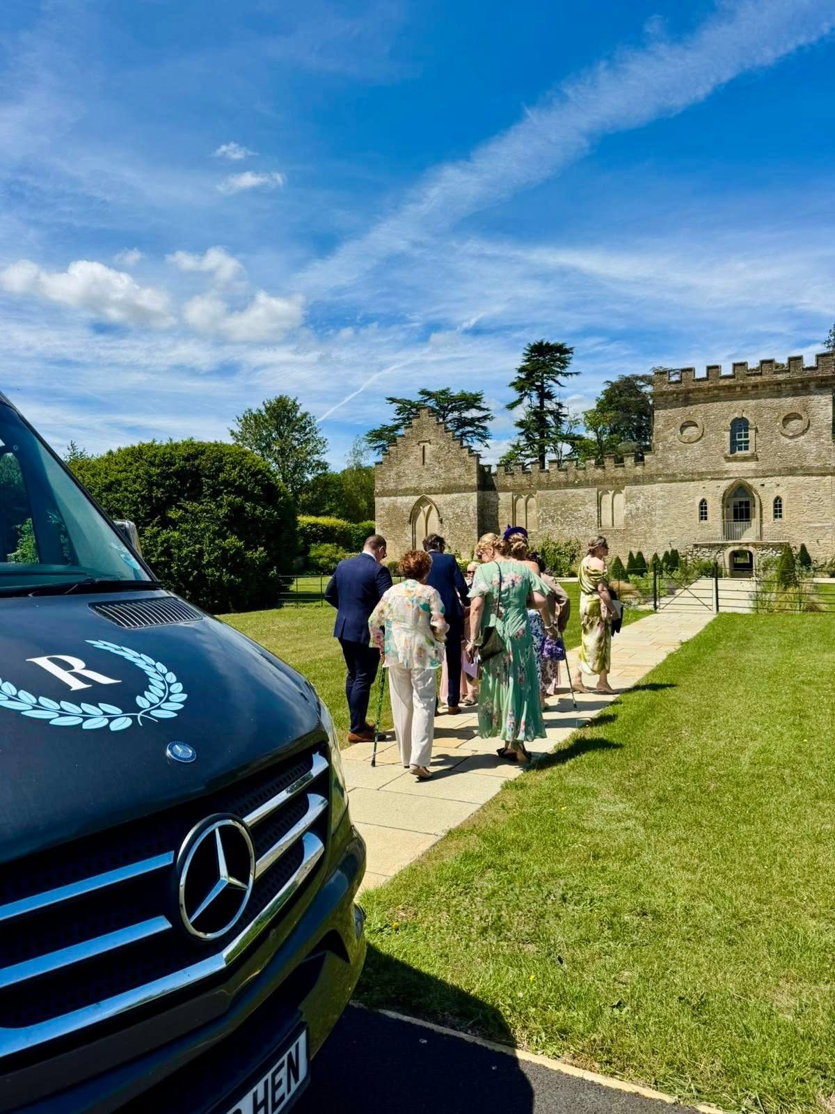Wedding guests walking towards a Cotswolds wedding venue
