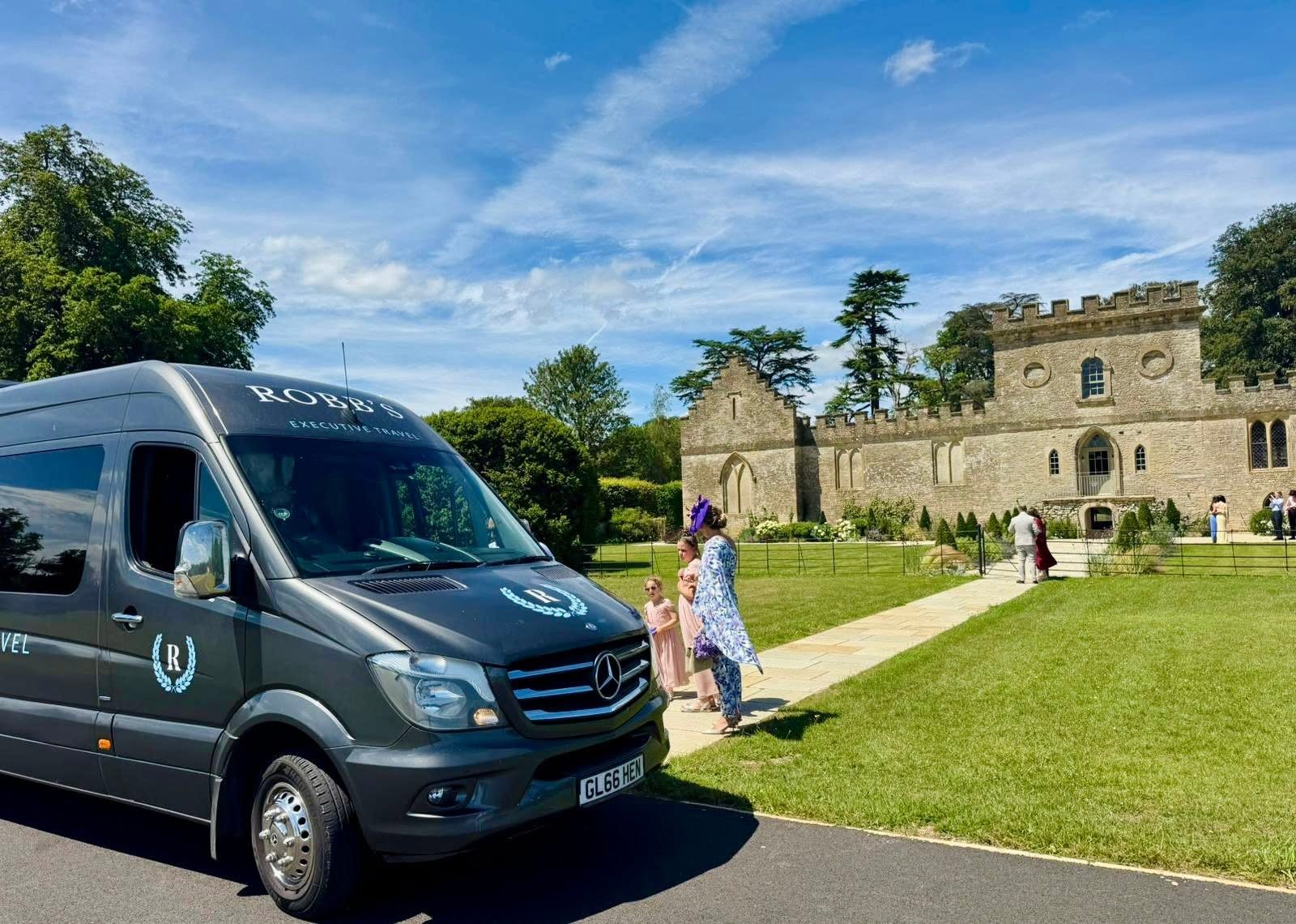 Robb's minibus parked outside a historic Cotswolds wedding venue