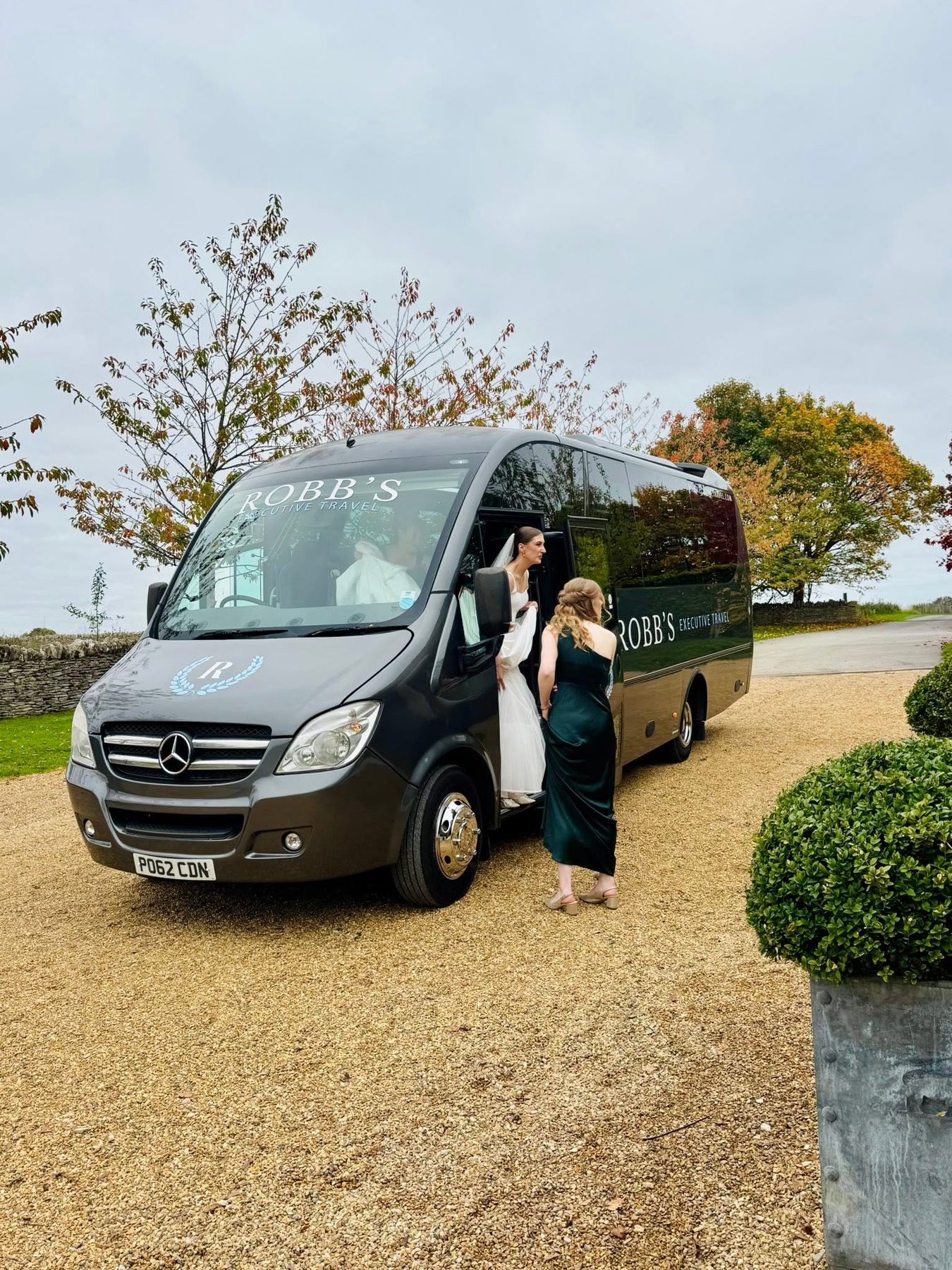 Bride boarding a Robb's minibus on her wedding day