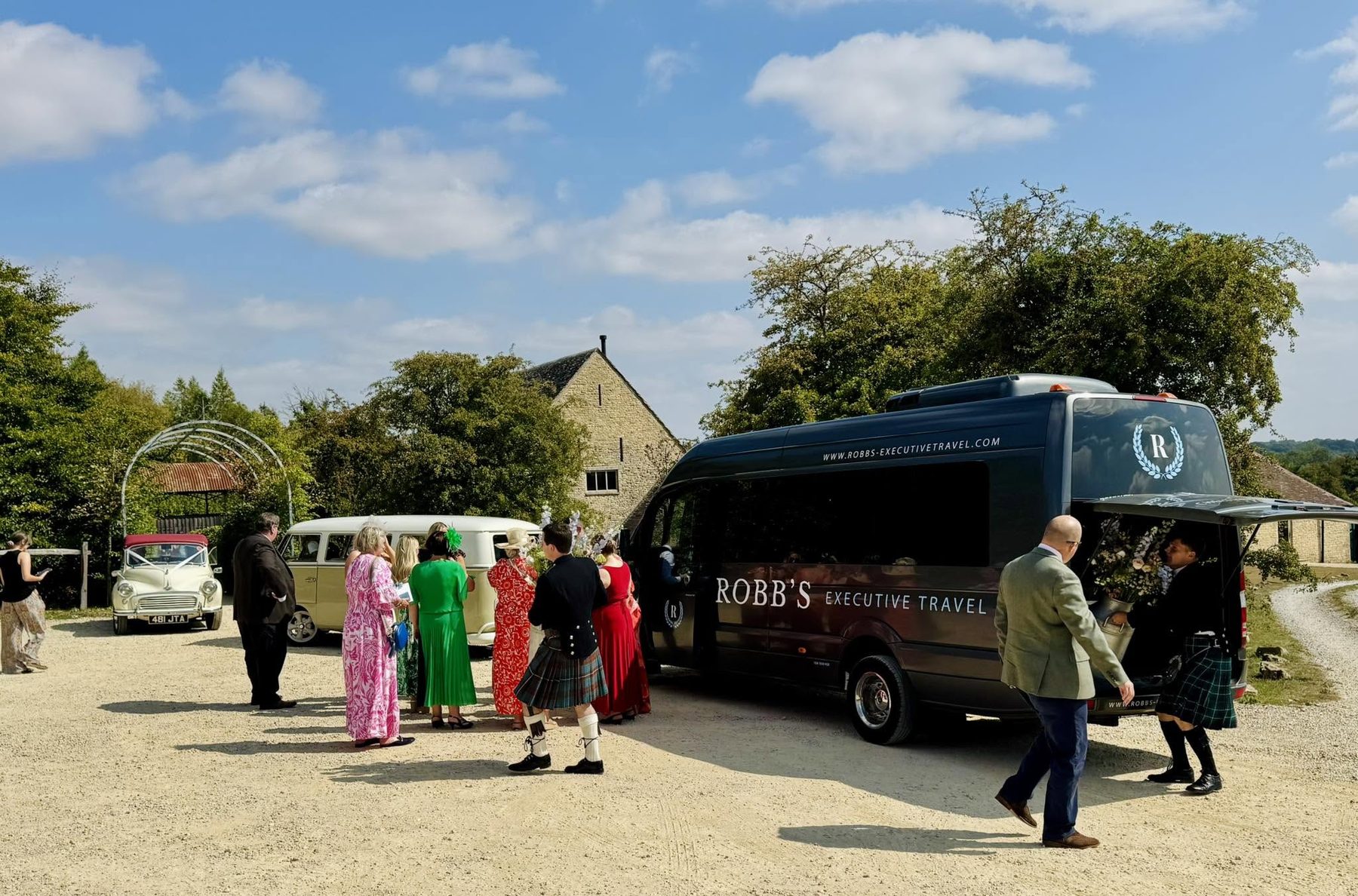 Wedding guests in kilts loading onto a Robb's minibus